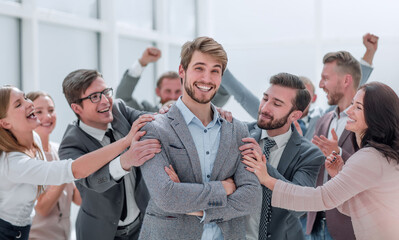 close up. cheerful company employees applauding their colleague.