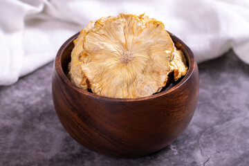 Dried pineapple slices. Sliced dried pineapple on dark background. Sun-dried fruit. close up
