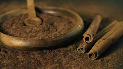 cinnamon ground sticks ceremony cocoa cloves ground coffee spices on wooden table closeup