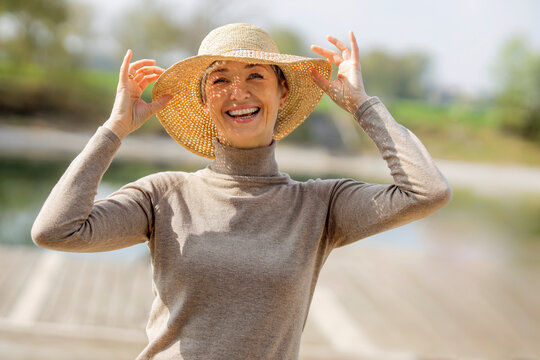 Happy Mature Woman Wearing Hat