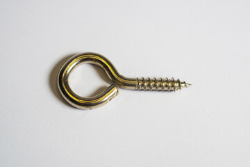 Single hook screw eye, hook screw isolated on a white background. Gold hook screw eye.