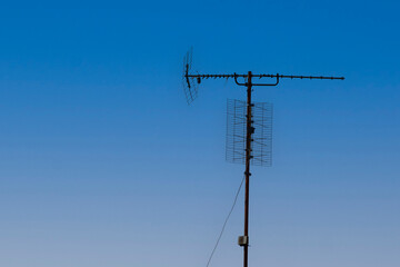old tv antenna and blue sky