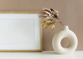 Frame mockup , modern ceramic vases with dry flower protea on white background near beige wall.Neutral color. Photo frame, poster template . Scandinavian interior. Copy space.