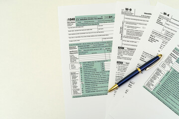 Tax Form 1040 per tax year for individual U.S. tax returns with a pen next to it.