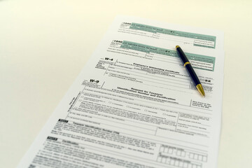Tax Form 1040 per tax year for individual U.S. tax returns with a pen next to it.