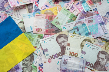 Ukrainian hryvnia banknotes on the national flag of Ukraine.