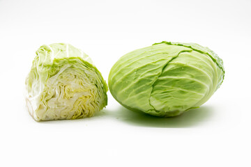 Whole and slices fresh green Cabbage isolated on white background.