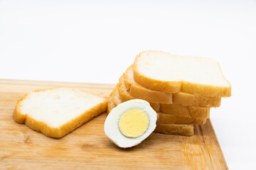 Some slices of bread with boiled egg slices on white background.