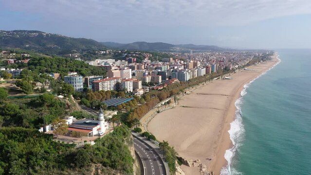 Birds eye view of Calella, Spain. Residential building along Mediterranean sea coast and beach visible from above.