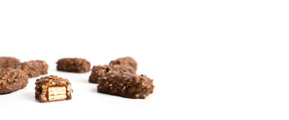 Chocolate candy bars wafers handmade lie on a white background. Top vew, flat lay. Banner