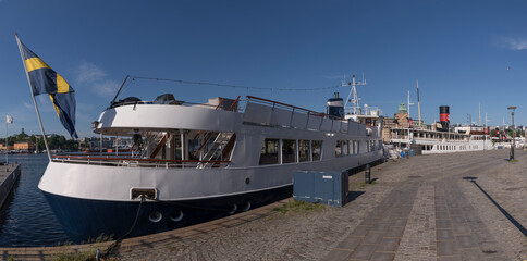 Commuting boats in the bay Nybroviken a sunny summer day morning in Stockholm