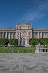 Fototapeta premium The parliament house with flags a sunny summer day morning in Stockholm