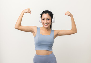 Fototapeta na wymiar Sexy sporty fitness asian woman with sportswear put on headphone isolated white background. Portrait Good shape and healthy woman standing pose exercise workout in studio.