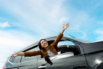 Young beautiful asian women getting new car. she very happy and excited. Smiling female driving...