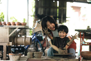 Happy family moment Mother and little boy crafting pottery clay workshop. Child creative activities and art. Kid playing modeling clay in pottery workshop. Developing children's learning skills.