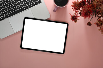 Mockup digital tablet, laptop computer, coffee cup and flower pot on pink background