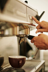Hands is barista making cup of coffee for customer