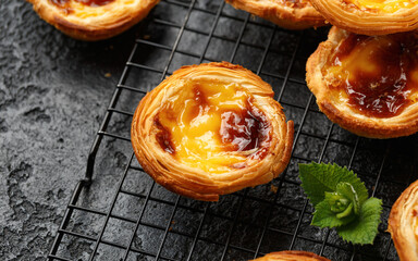 Traditional Portuguese custard tarts or Pastel de Nata freshly baked and cooling on rack