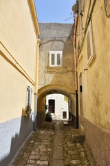 Fototapeta na wymiar A narrow street among the old houses of Irsina in Basilicata, region of southern Italy.