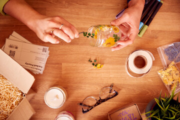 Close Up Of Woman Making Boutique Flower Candles To Sell Online Working From Home