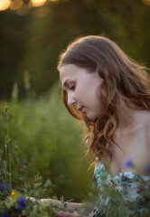 Photo of a beautiful girl in a summer meadow.