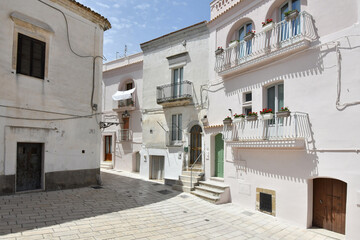 Fototapeta na wymiar A narrow street among the old houses of Irsina in Basilicata, region in southern Italy.