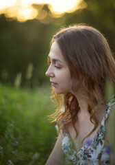 Naklejka premium Photo of a beautiful girl in a summer meadow.