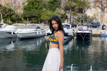 Cheerful Asian woman standing on pier