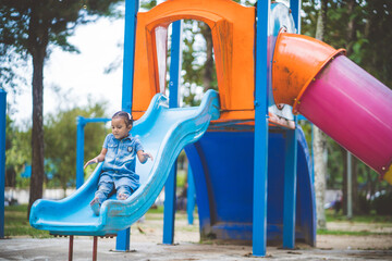 The girls enjoy playing slides in the playground.