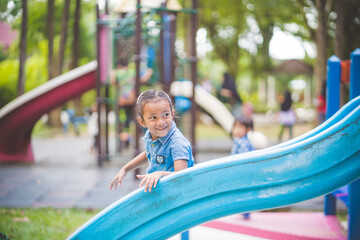 Fototapeta na wymiar The girls enjoy playing slides in the playground.