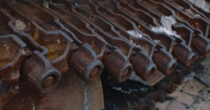 Close-up detailed tracking shot -  caterpillar  track of a burnt-out Russian tank. Exibition in Kyiv on Sophia Square Rushy Military vehicle destroyed by the explosion of Ukrainian artillery shelling