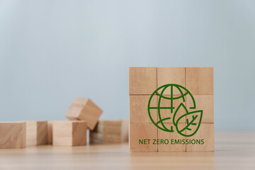 Net Zero and Carbon Neutral Concepts Net Zero Emissions Goals A climate-neutral long-term strategy green net center icon on wooden block and world record icon on gray background