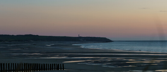 Panorama Cap Gris-Nez with lighthouse in beautiful twilight after sunset on opal coast at the north sea with sandy beach in foreground, Wissant, France