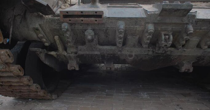 Close-up detailed tracking shot -  caterpillar  track of burnt-out Russian modern tank t 90. Exibition in Kyiv on Sophia Square  Military vehicle destroyed by  Ukrainian artillery shelling
