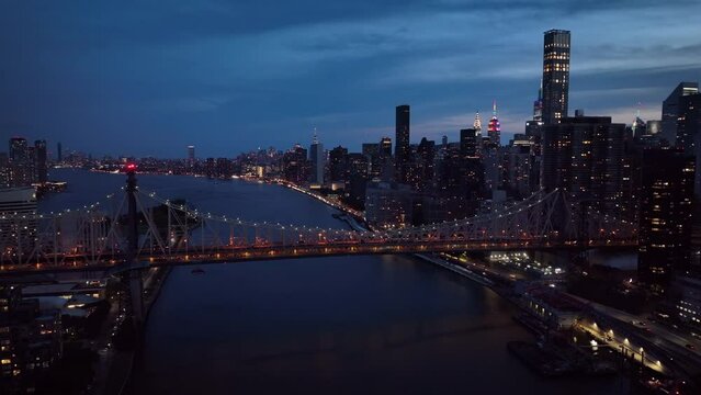 dusk flying clockwise view of Ed Koch Queensboro Bridge and NYC skyline