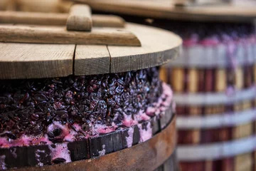 Fotobehang fermentation of grapes in a barrel for making wine © serdiukov