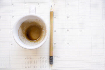 empty cup of coffee on a work diary