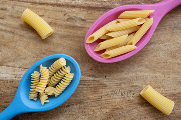 Fototapeta na wymiar variety of pasta and kitchen ladles