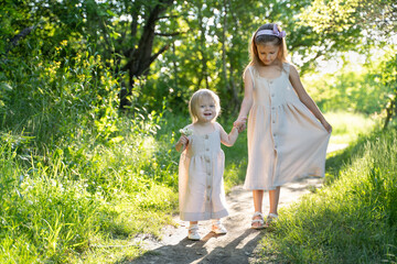 Fototapeta premium two girls are walking in the park