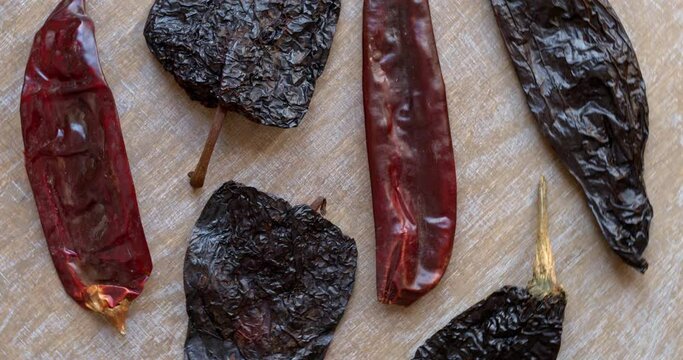 Dry chili peppers: Guajillo, Ancho and Pasilla top view. Table spin.