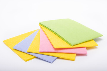 Multicolored cleaning cloths on the white background. Napkins for cleaning. Folded textile napkins. Cleaning Cloth, top view
