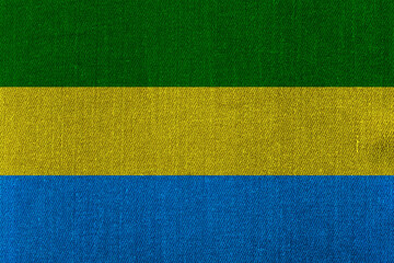 Patriotic classic denim background in colors of national flag. Gabon