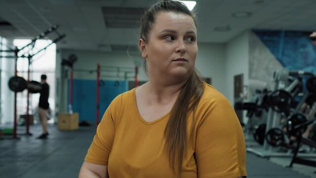 Caucasian woman with overweight feel uncomfortable at the gym. Shot with RED helium camera in 4K.  