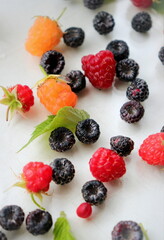 black yellow and red raspberries garden close-up soft selective focus, organic berries