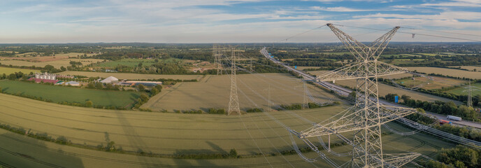 Power line, power supply and biogas plant on the backgroung with countryside landscape. Electricity...