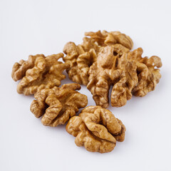 dried walnuts on a white acrylic background