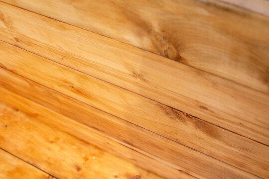 Texture of wooden panels. Decorative decoration of the wall and roof made of natural yellow wood.