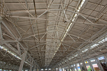 Interior of abandoned steel frame workshop factory building in industrial area