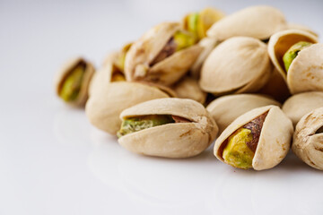 fresh salted pistachios on a white background