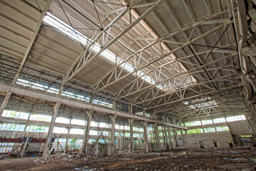 Interior of abandoned steel frame workshop factory building in industrial area